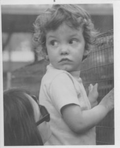 black and white photo curly-haired toddler held by mother